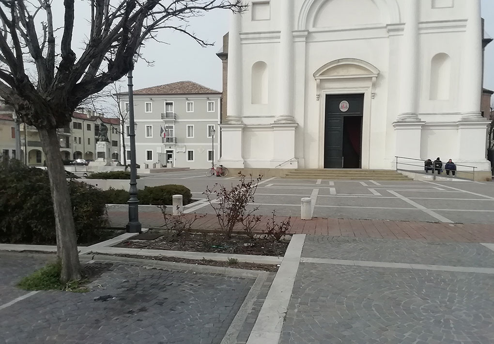 una piazza con alberi davanti a una chiesa